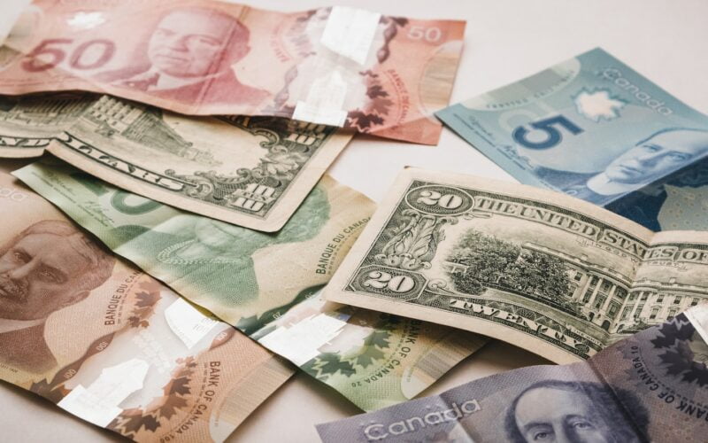 a pile of canadian money sitting on top of a table