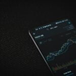 black android smartphone on black textile