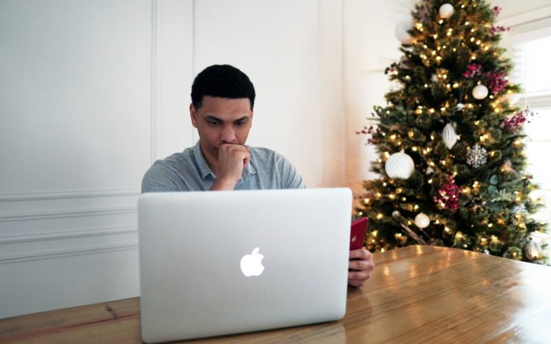 man in gray crew neck shirt sitting in front of silver macbook