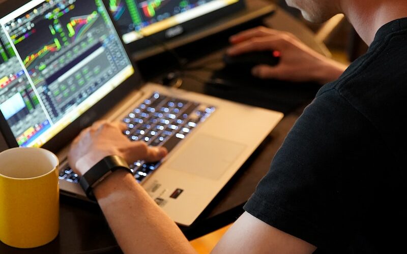 man sitting in front of the laptop