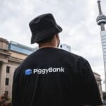 a man wearing a piggy bank shirt and a hat