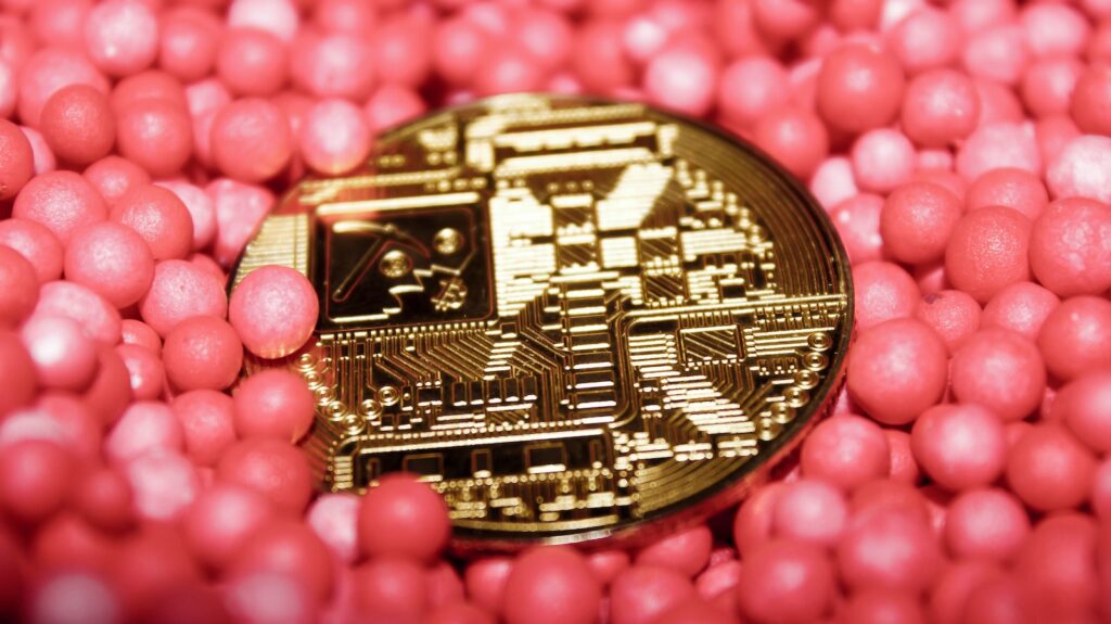 a close up of a coin surrounded by pink balls