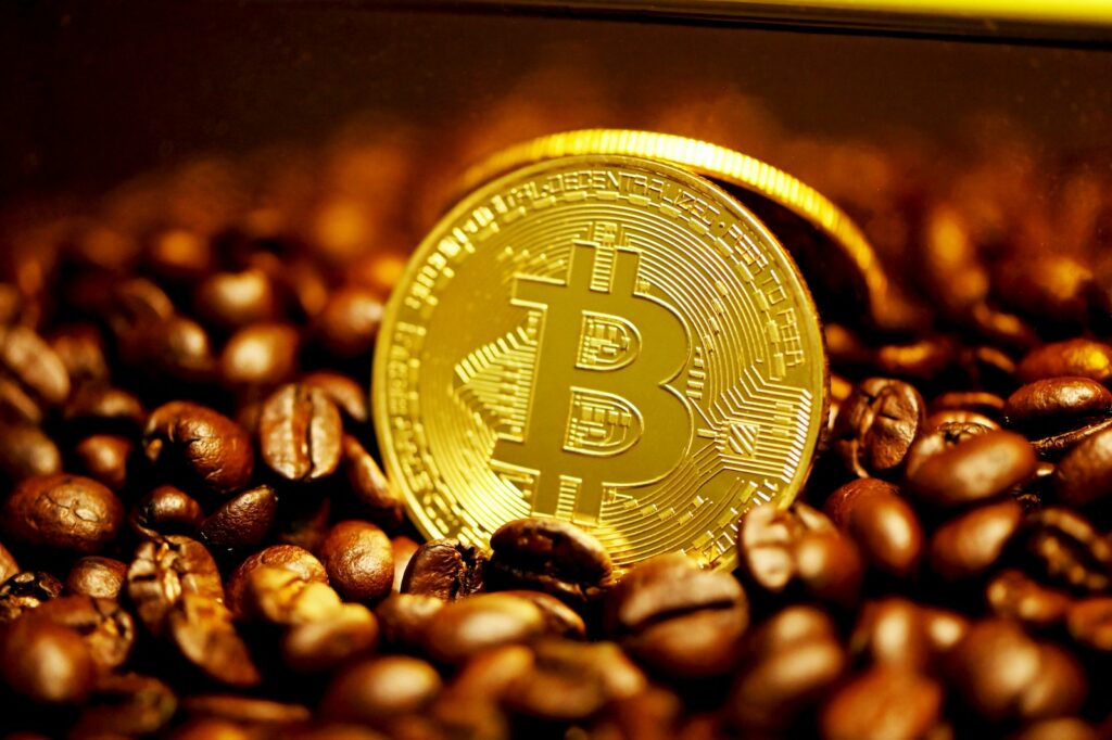 gold round coin on brown coffee beans