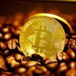 gold round coin on brown coffee beans