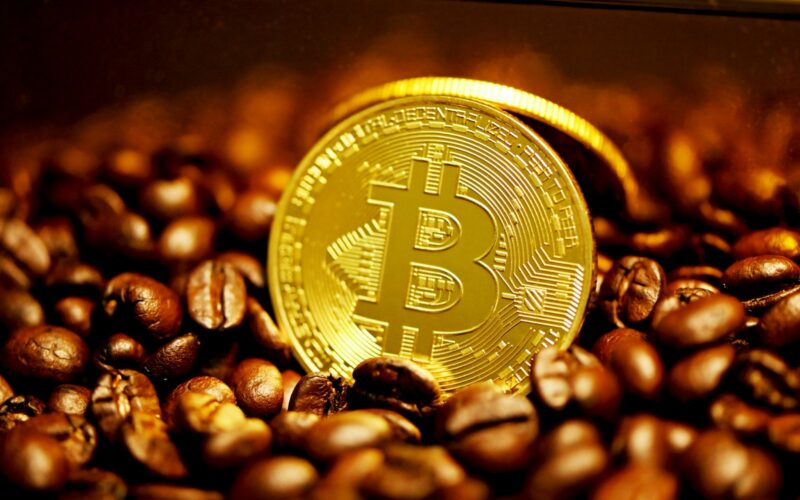 gold round coin on brown coffee beans